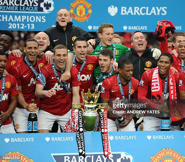 Manchester United players celebrate with the Premier League trophy after the presentation at the end of the Premier League champions at the end of...