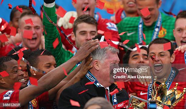 Manchester United Manager Sir Alex Ferguson celebrates with his players and the Premier League trophy following the Barclays Premier League match...