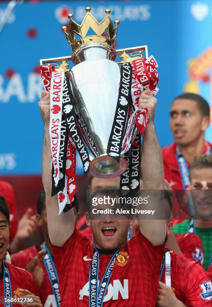 Wayne Rooney of Manchester United lifts the Premier League trophy following the Barclays Premier League match between Manchester United and Swansea...