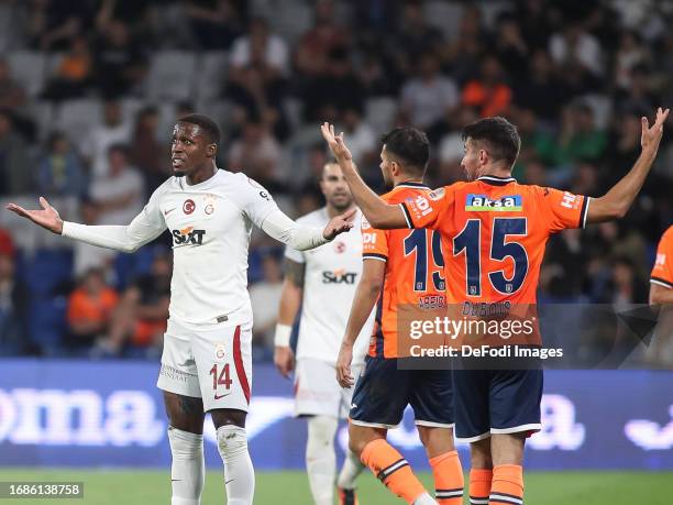 Wilfried Zaha of Galatasaray, Leo Dubois of Istanbul Basaksehir gestures during the Turkish Super League match between Basaksehir and Galatasaray at...