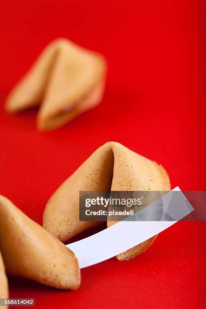 fortune cookies on red paper - fortune cookie stock pictures, royalty-free photos & images