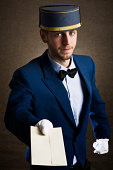 Bellboy holding an envelope as copy space