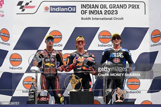 First placed Red Bull KTM Ajo's Spanish rider Pedro Acosta , second placed Elf Marc VDS Racing Team's Italian rider Tony Arbolino and third placed...