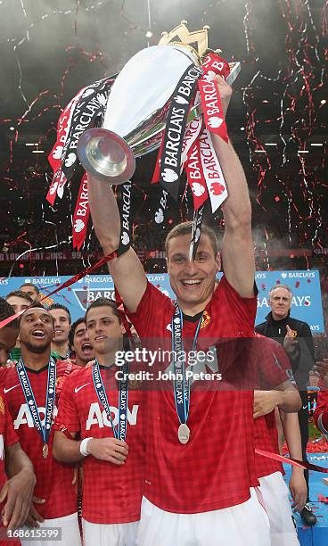 Nemanja Vidic of Manchester United lifts the Premier League trophy after the Barclays Premier League match between Manchester United and Swansea at...