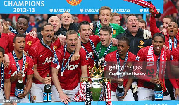 The Manchester United players celebrate with the Premier League trophy following the Barclays Premier League match between Manchester United and...