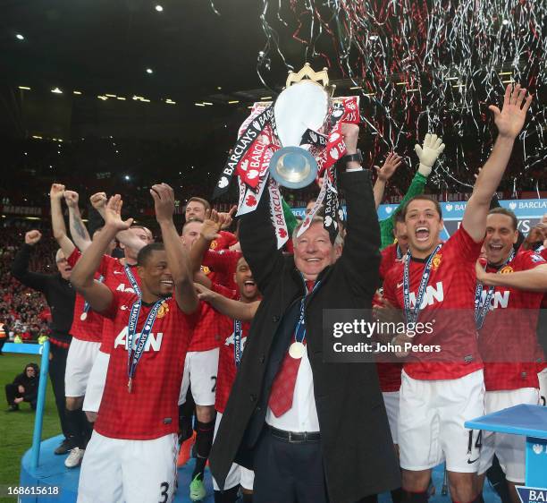 Manager Sir Alex Ferguson of Manchester United lifts the Premier League trophy after the Barclays Premier League match between Manchester United and...