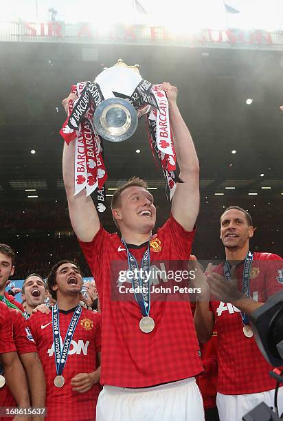 Phil Jones of Manchester United lifts the Premier League trophy after the Barclays Premier League match between Manchester United and Swansea at Old...