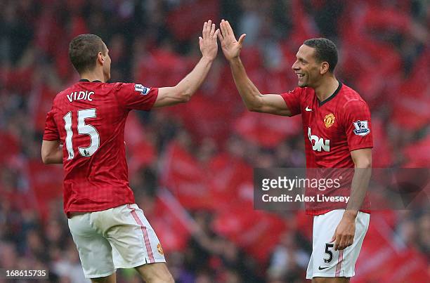 Rio Ferdinand of Manchester United celebrates scoring the winning goal with team-mate Nemanja Vidic during the Barclays Premier League match between...