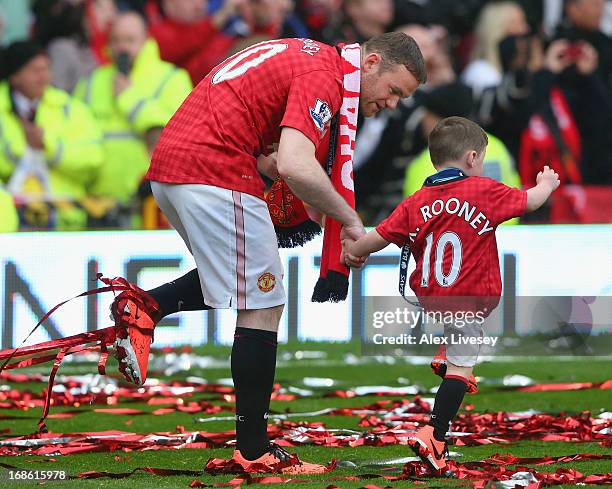 Wayne Rooney of Manchester United walks with his son Kai following the Barclays Premier League match between Manchester United and Swansea City at...