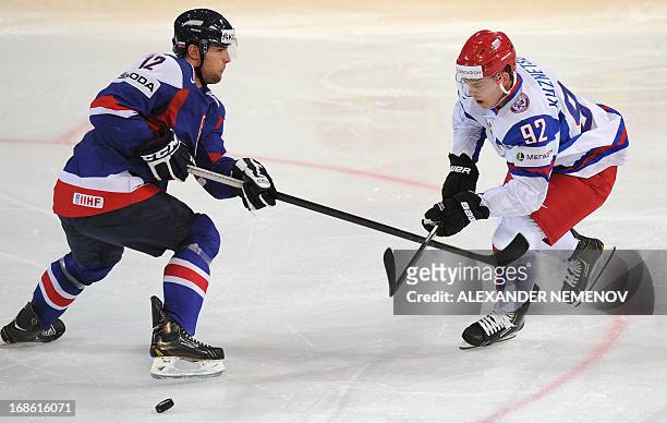 Slovakia's defender Ivan Svarny vies with Russia's forward Yevgeny Kuznetsov during the preliminary round match Slovakia vs Russia at the 2013 IIHF...