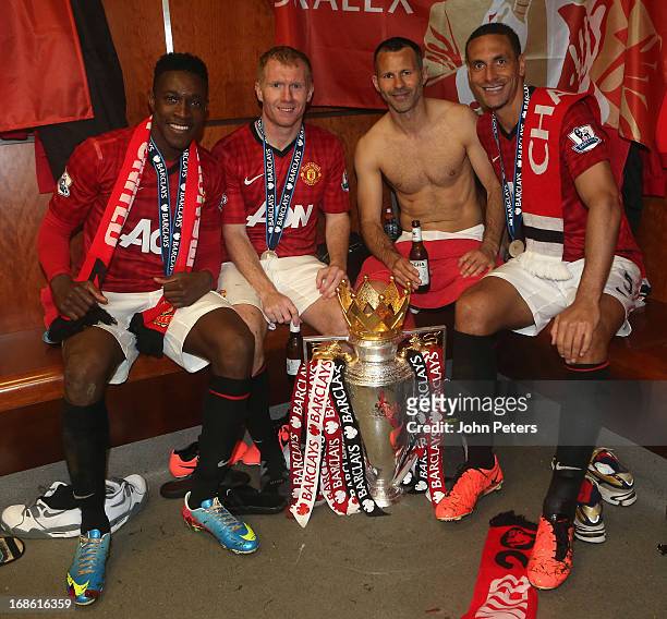 Danny Welbeck, Paul Scholes, Ryan Giggs and Rio Ferdinand of Manchester United celebrate with the Barclays Premier League trophy in the dressing room...