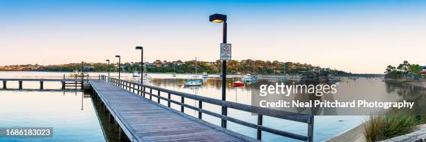 jetty pier in early morning light along river - australia jetty stock pictures, royalty-free photos & images