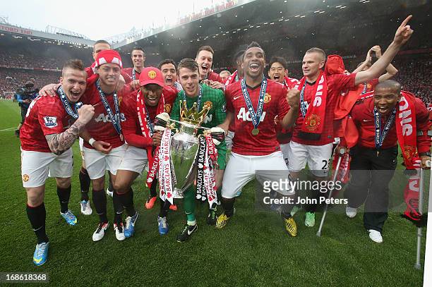 The Manchester United squad celebrate with the Premier League trophy after the Barclays Premier League match between Manchester United and Swansea at...