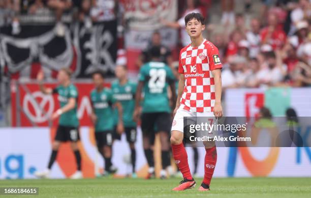 Jae-sung Lee of Mainz reacts after Serhou Guirassy of Stuttgart scored the team's third goal during the Bundesliga match between 1. FSV Mainz 05 and...