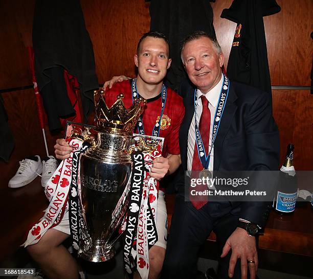 Phil Jones and Manager Sir Alex Ferguson of Manchester United celebrate with the Barclays Premier League trophy in the dressing room after the...