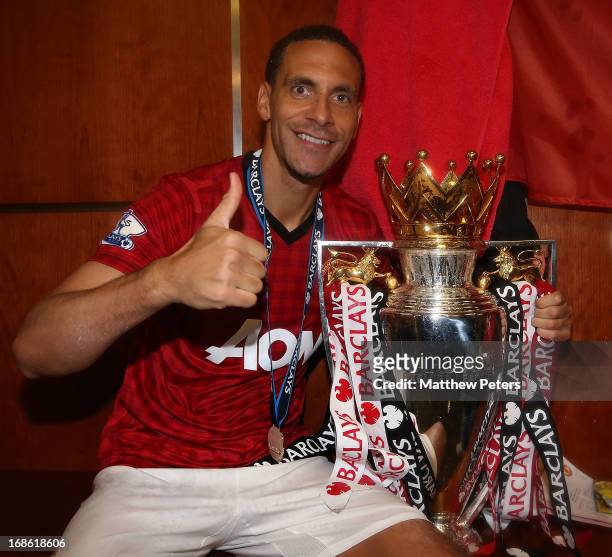 Rio Ferdinand of Manchester United celebrates with the Barclays Premier League trophy in the dressing room after the Barclays Premier League match...