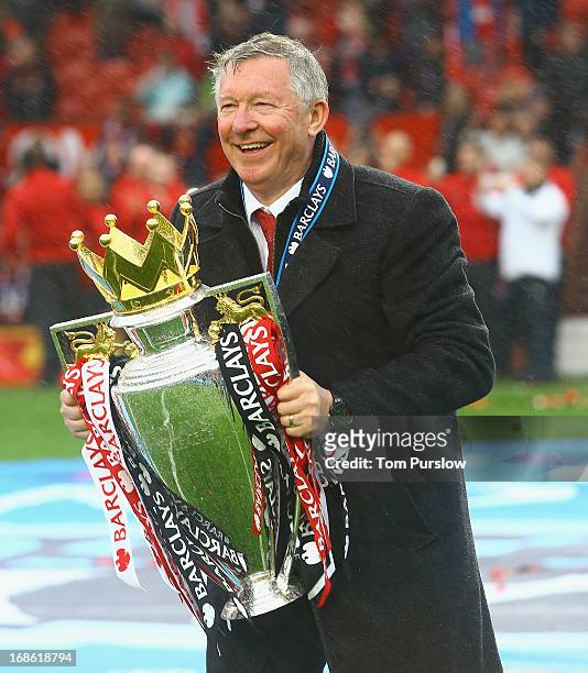 Manager Sir Alex Ferguson of Manchester United poses with the Premier League trophy after the Barclays Premier League match between Manchester United...