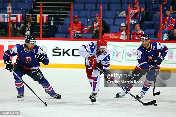 Alexander Radulov of Russia and Michel Miklik of Slovakia battle for the puck during the IIHF World Championship group H match between Slovakia and...