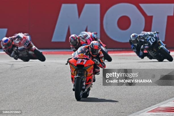 Red Bull KTM Ajo's Spanish rider Pedro Acosta leads his bike during the Moto2 race of the Indian Grand Prix at the Buddh International Circuit in...