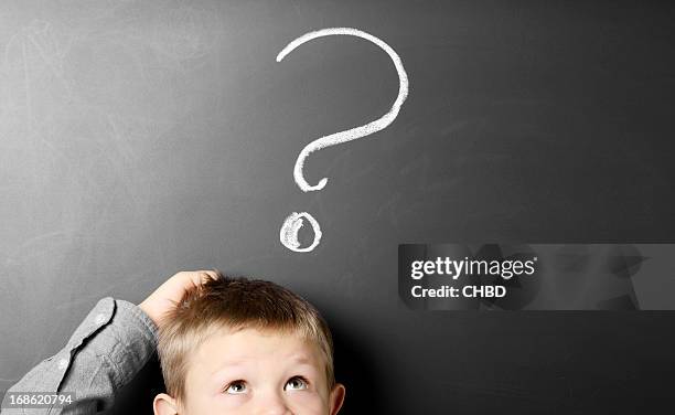 small boy scratching his head and looking confused - scratching head stock pictures, royalty-free photos & images