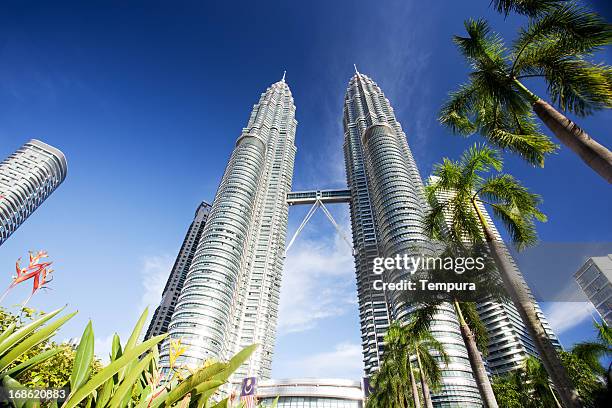 kuala lumpur's petronas twin towers against blue sky - petronas towers stock pictures, royalty-free photos & images