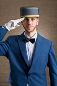 Bellboy saluting with respect.