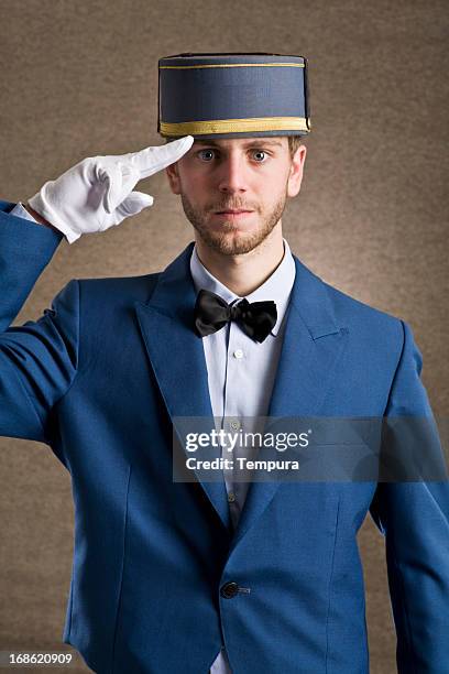 bellboy saluting with respect. - bell boy stock pictures, royalty-free photos & images