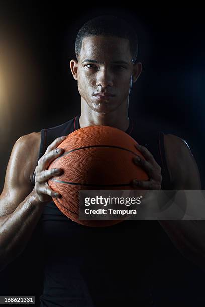 streetball player's portrait _ vertical - young man holding basketball stockfoto's en -beelden