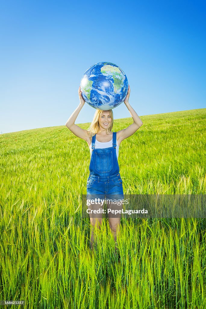 Cheerful girl holding a world globe