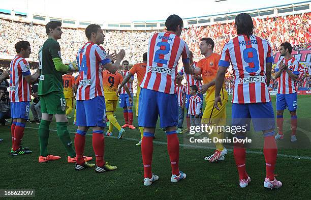 Atletico de Madrid players congratulates Lionel Messi and teammates of FC Barcelona after Barcelona were proclaimed La Liga champions prior to the La...