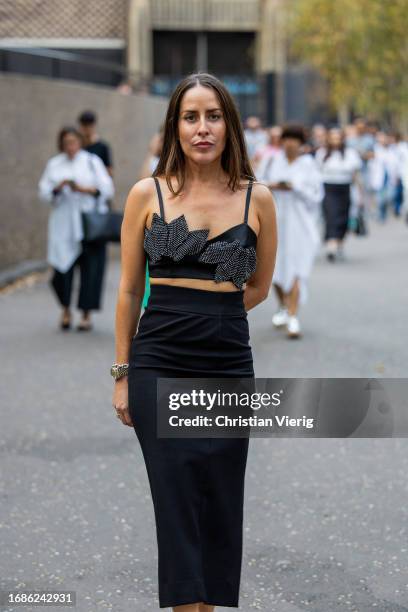 Idalia Salsamendi wears black top, skirt outside David Koma during London Fashion Week September 2023 at the on September 16, 2023 in London, England.