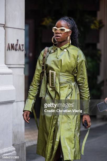 Guest wears green coat outside Richard Quinn during London Fashion Week September 2023 at the on September 16, 2023 in London, England.