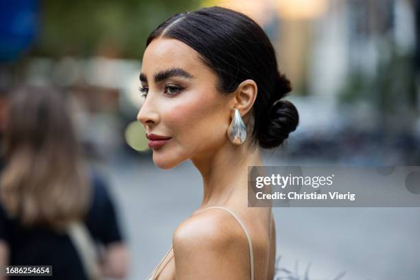 Guest wears silver Bottega Veneta earrings outside David Koma during London Fashion Week September 2023 at the on September 16, 2023 in London,...