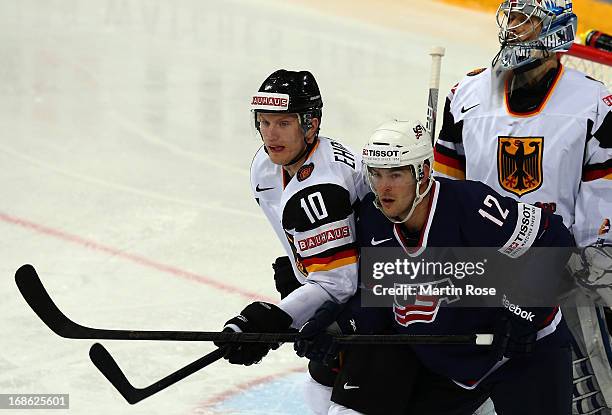 Bobby Butler of USA and Christian Ehrhoff of Germany battle for position in front of the net during the IIHF World Championship group H match between...