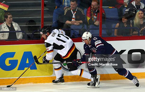 Craig Smith of USA and Marcus Kink of Germany battle for the puck during the IIHF World Championship group H match between USA and Germany at...