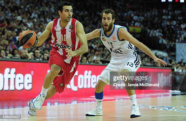 Rudy Fernandez of Real Madrid tussles with Acie Law of Olympiacos Piraeus during the Turkish Airlines EuroLeague Final Four final between Olympiacos...