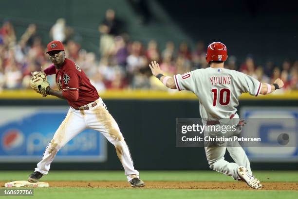 Infielder Didi Gregorius of the Arizona Diamondbacks throws over the sliding Michael Young of the Philadelphia Phillies to complete a double play...