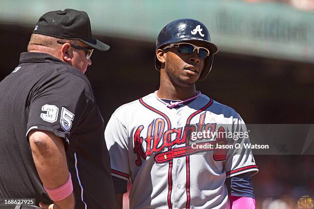 Justin Upton of the Atlanta Braves argues a called third strike with umpire Wally Bell during the sixth inning against the San Francisco Giants at...