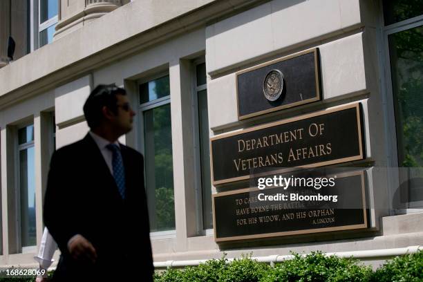 Pedestrian walks past the U.S. Department of Veterans Affairs headquarters in Washington, D.C., U.S., on Friday, May 10, 2013. The department's...