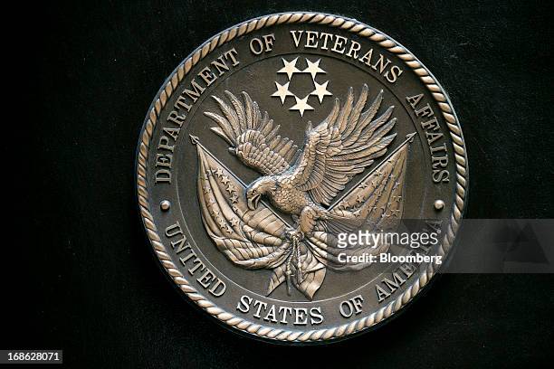 The U.S. Department of Veterans Affairs seal hangs on the facade at the headquarters in Washington, D.C., U.S., on Friday, May 10, 2013. The...