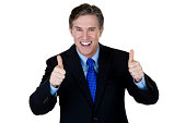 Excited businessman gesturing thumbs up