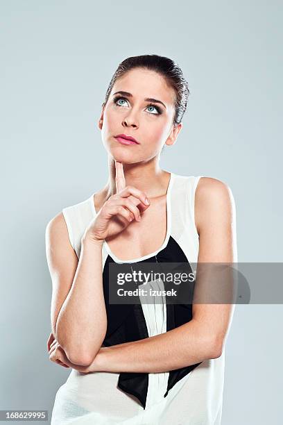 thinking young woman, studio portrait - woman thinking hand on chin stock pictures, royalty-free photos & images