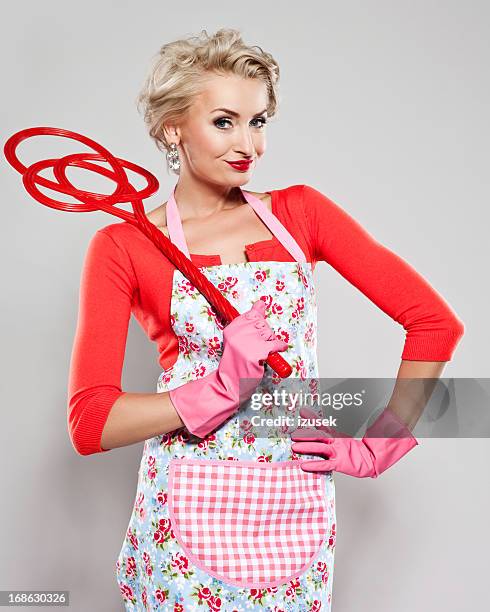 elegant woman with carpet beater - wife beater stock pictures, royalty-free photos & images