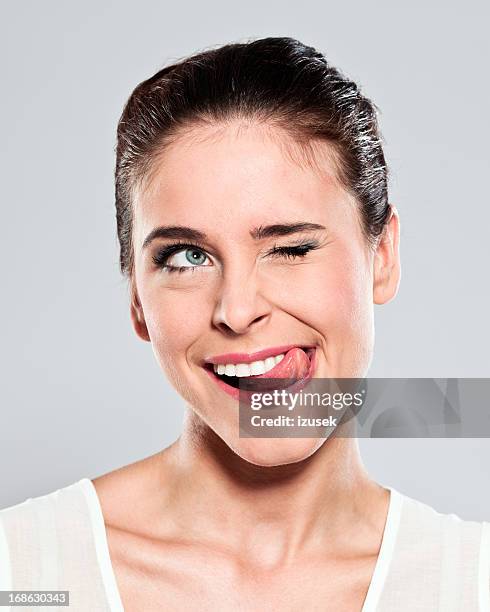 attractive young woman grimacing - mouth thinking stockfoto's en -beelden