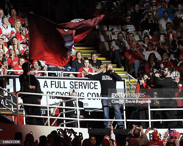 Former Red Wing Darren McCarty gets the fans reved up before Game Four of the Western Conference Quarterfinals between the Anaheim Ducks and the...