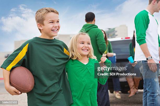 excited kids watching football game at tailgate party - young supporter stock pictures, royalty-free photos & images