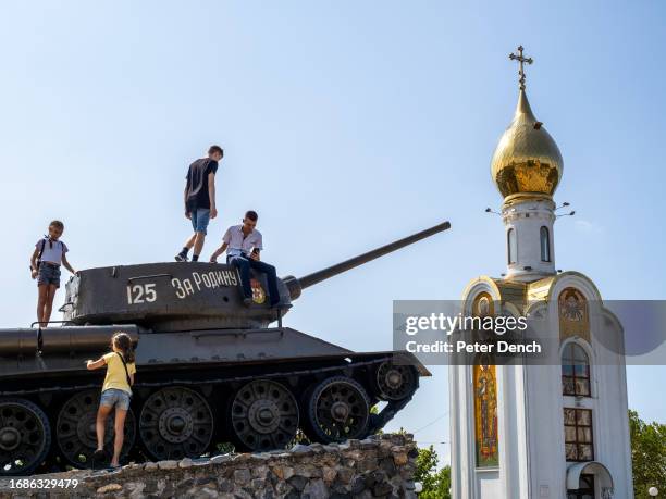 Decommissioned T-34 tank being used as a climbing frame, part of the Memorial of Glory monument positioned next to the orthodox church Sfantul...