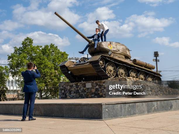 Decommissioned T-34 tank being used as a climbing frame, part of the Memorial of Glory monument positioned next to the orthodox church Sfantul...