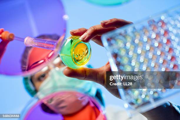 technician at a laboratory surrounded by lab tools - biochemistry stock pictures, royalty-free photos & images