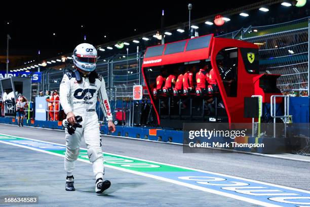 15th placed qualifier Yuki Tsunoda of Japan and Scuderia AlphaTauri walks in the Pitlane during qualifying ahead of the F1 Grand Prix of Singapore at...